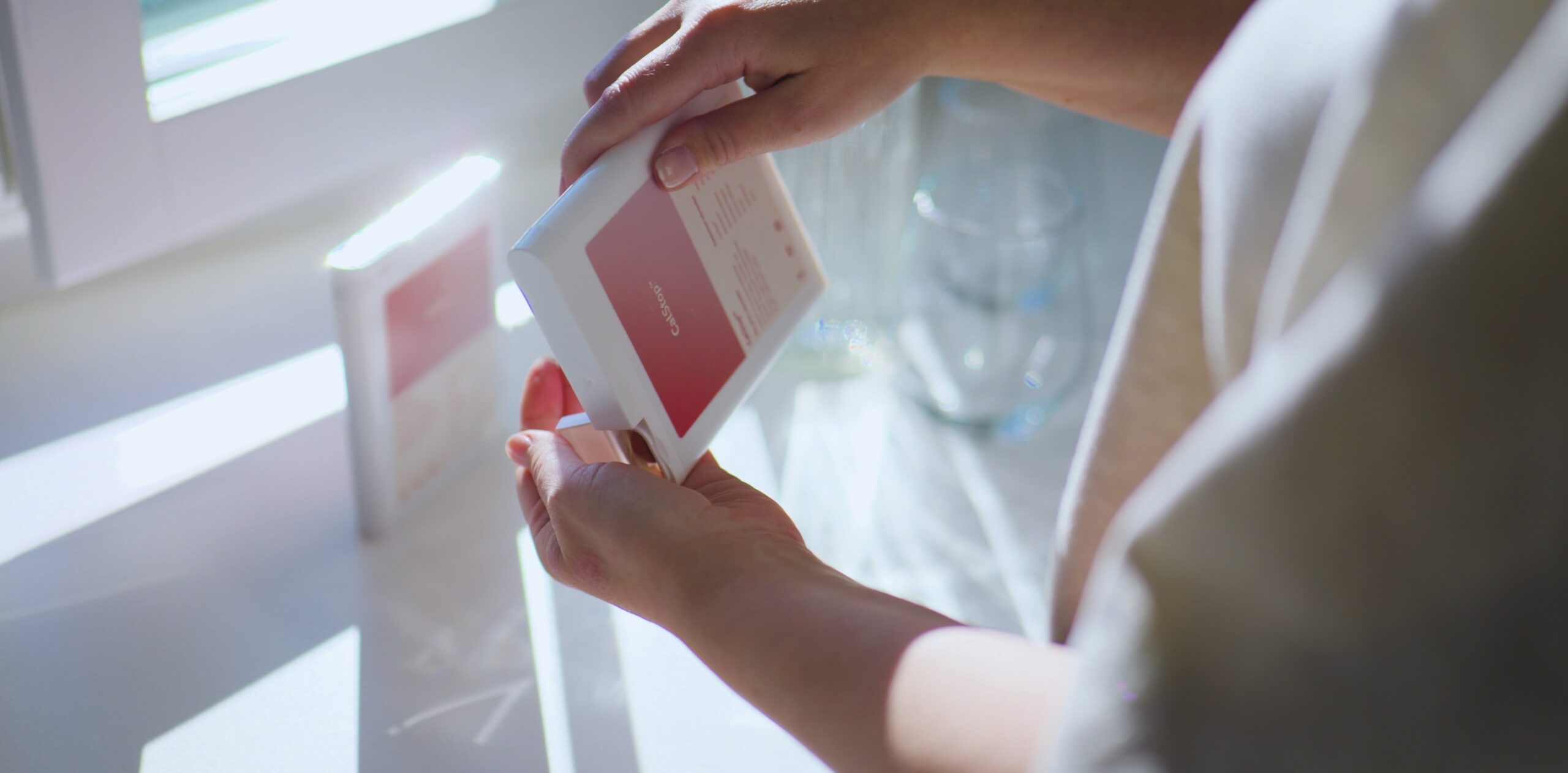 Person holder CalStop-produkt i hånden i naturlig dagslys – del av reklamefilm.